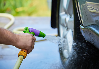 Image showing People cleaning car using high pressure water