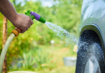 Image showing People cleaning car using high pressure water