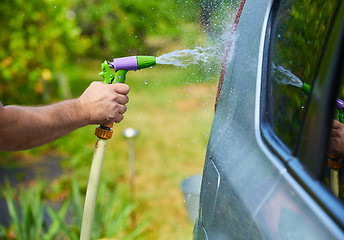 Image showing People cleaning car using high pressure water