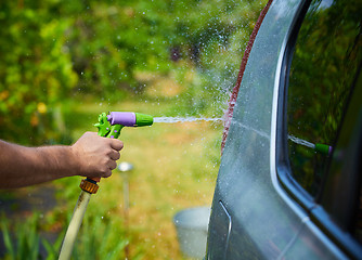 Image showing People cleaning car using high pressure water