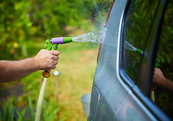 Image showing People cleaning car using high pressure water