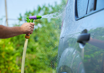 Image showing People cleaning car using high pressure water