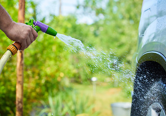 Image showing People cleaning car using high pressure water