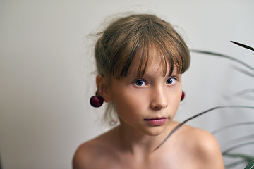 Image showing Little girl with a cherry on her ears