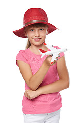 Image showing Lovely little girl wearing tourist hat holding small airplane toy