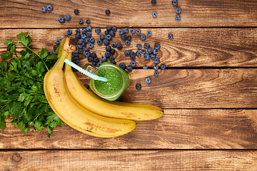 Image showing Mug with green smoothie drink and bundle of fresh parsley