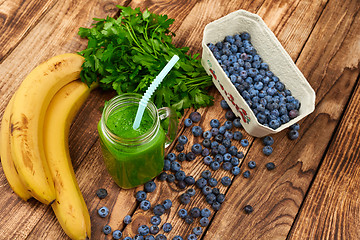 Image showing Mug with green smoothie drink and bundle of fresh parsley