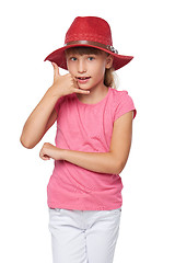 Image showing Little girl in traveler hat making a call me gesture