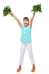 Image showing Smiling little girl showing fresh parsley screaming of joy