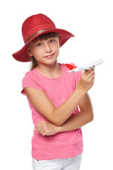 Image showing Lovely little girl wearing tourist hat holding small airplane toy