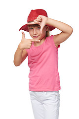 Image showing Little girl wearing traveler hat making frame with her hands