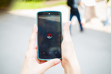 Image showing Moscow, Russia - August, 02: Android user play in Pokemon Go augmented reality mobile game on smartphone.