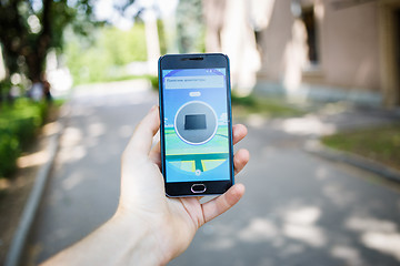 Image showing Moscow, Russia - August, 02: Android user play in Pokemon Go augmented reality mobile game on smartphone.