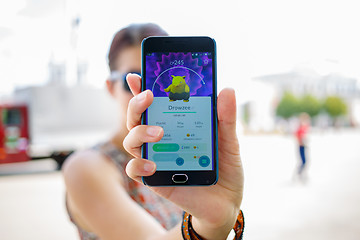 Image showing Moscow, Russia - August, 02: Android user play in Pokemon Go augmented reality mobile game on smartphone.