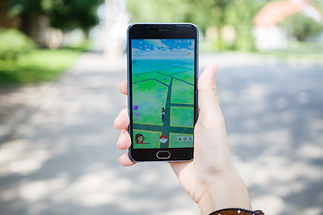 Image showing Moscow, Russia - August, 02: Android user play in Pokemon Go augmented reality mobile game on smartphone.