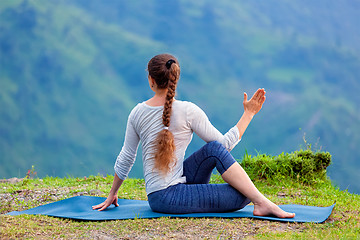 Image showing Woman practices yoga asana outdoors