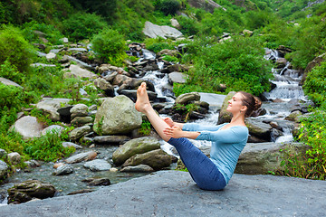 Image showing Woman doing Ashtanga Vinyasa Yoga asana Navasana outdoors