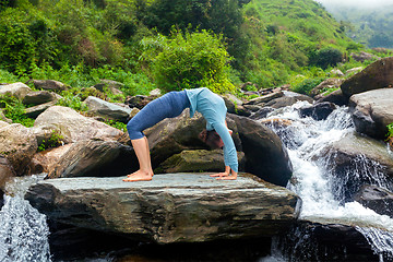 Image showing Woman doing Ashtanga Vinyasa Yoga asana Urdhva Dhanurasana  - up