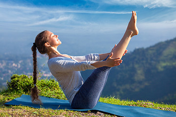 Image showing Woman doing Ashtanga Vinyasa Yoga asana Navasana - boat pose