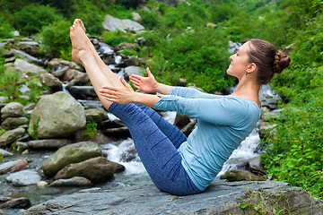 Image showing Woman doing Ashtanga Vinyasa Yoga asana Navasana outdoors