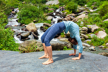 Image showing Woman doing Ashtanga Vinyasa Yoga asana Urdhva Dhanurasana  - up