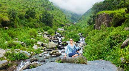 Image showing Woman doing Ardha matsyendrasanaasana asana outdoors