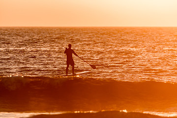 Image showing Stand up paddler silhouette at sunset