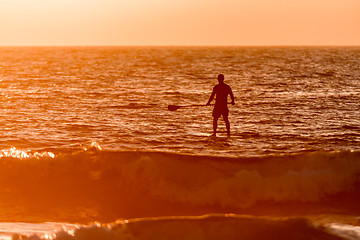 Image showing Stand up paddler silhouette at sunset