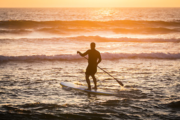 Image showing Stand up paddler silhouette at sunset