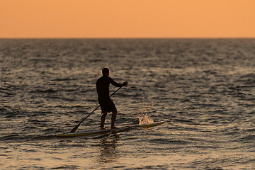 Image showing Man paddleboarding