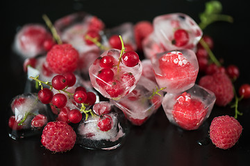 Image showing Frozen berries on wooden table