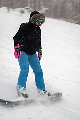 Image showing Woman doing exercise on snowboard