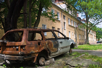 Image showing Burned-down vehicle on yard of residental house