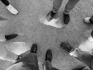 Image showing Three people feet in black and white