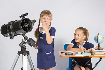 Image showing Girl astronomer thought, another girl with a smile looking at her