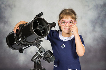 Image showing Girl astronomer happily surprised by what he saw in the telescope