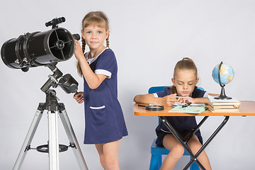 Image showing Girl watches in the telescope, the other girl is waiting for the results of observations