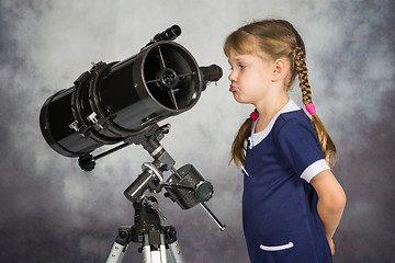 Image showing Girl disappointed by what he saw in the telescope