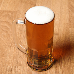 Image showing Single beer glass on wooden table