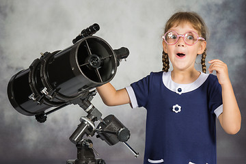 Image showing Girl astronomer happily surprised by what he saw in the telescope
