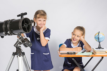 Image showing Girl mysteriously astronomer looks into the distance, a classmate with a smile looked at her