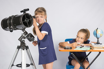 Image showing The girl was upset he did not see in the telescope, the other girl mocking her