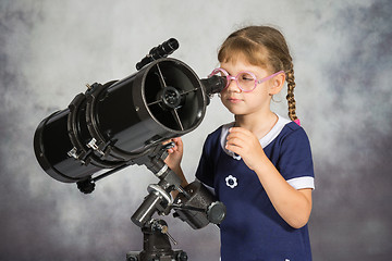 Image showing Girl astronomer happily surprised by what he saw in the telescope