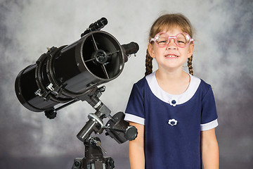 Image showing Girl bespectacled amateur astronomer funny smiling standing by telescope