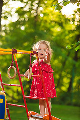 Image showing The little baby girl playing at outdoor playground