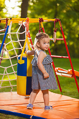 Image showing The little baby girl playing at outdoor playground