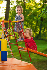 Image showing The two little baby girls playing at outdoor playground