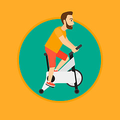 Image showing Man riding stationary bicycle.