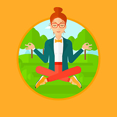 Image showing Business woman meditating in lotus position.