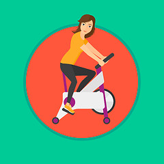 Image showing Woman riding stationary bicycle.